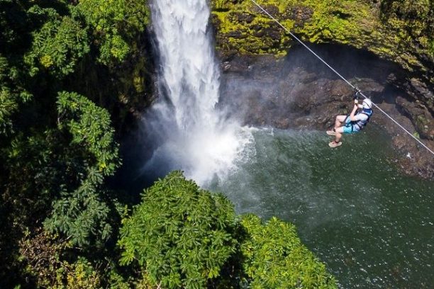 a large waterfall over some water